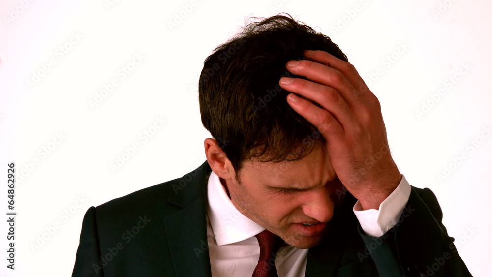 Businessman with headache touching his head Businessman with headache touching his head
