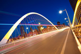Arc bridge girder highway car light trails city night landscape