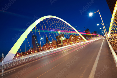 Arc bridge girder highway car light trails city night landscape © Aania