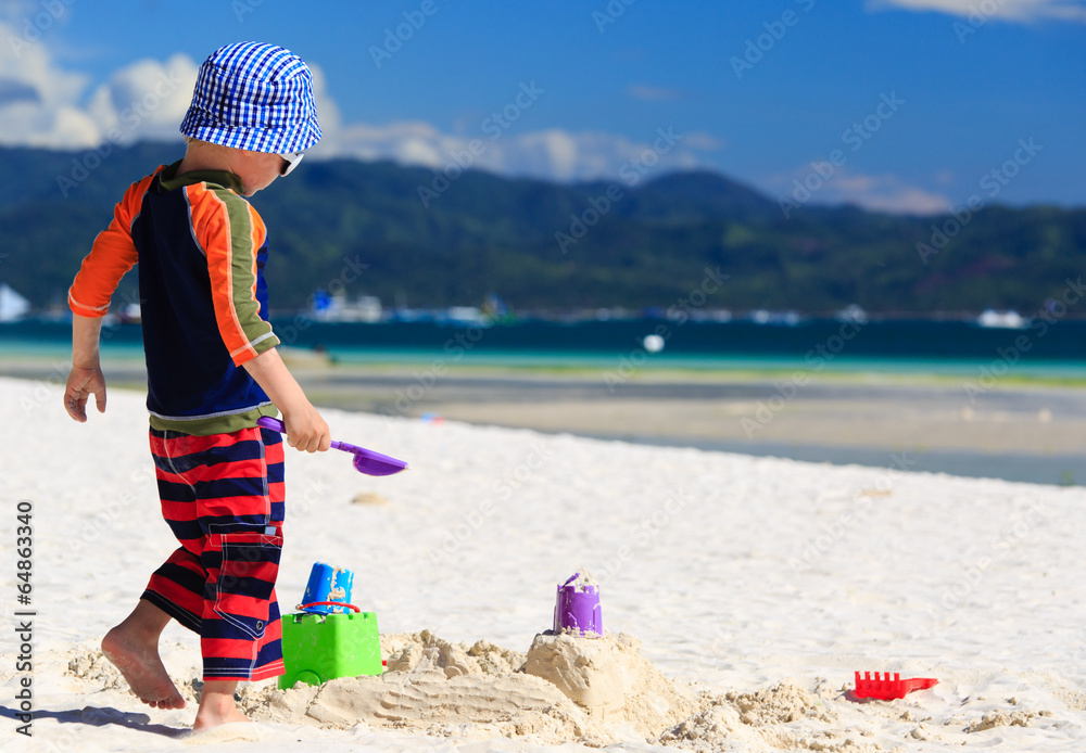 child building sandcastle