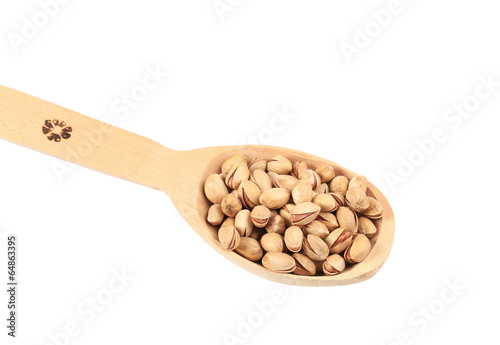 Wooden spoon with pistachios.