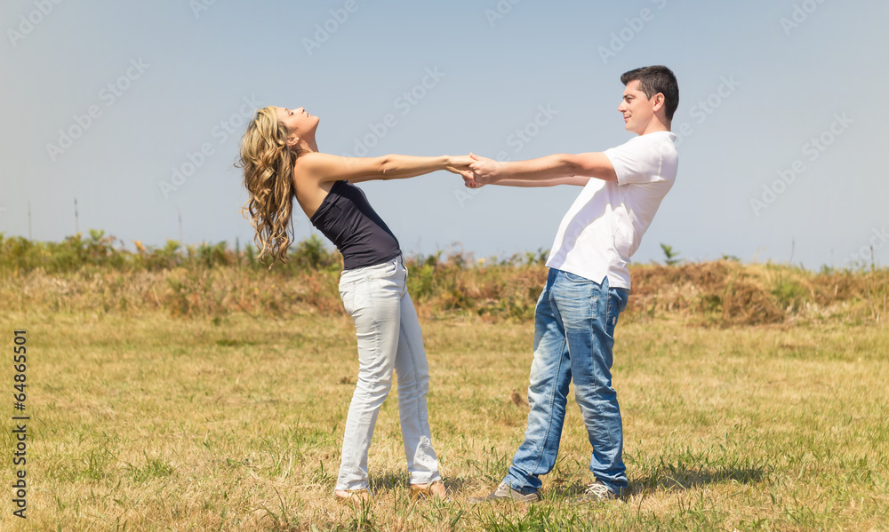 Love couple holding hands outdoors on a summer day Love couple holding hands outdoors on a summer day