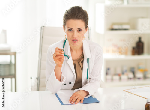 Free Download Medical doctor woman sitting in office and explaining - GFXLoad