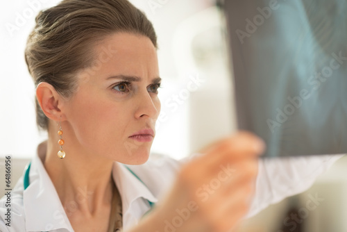 Concerned medical doctor woman looking on fluorography