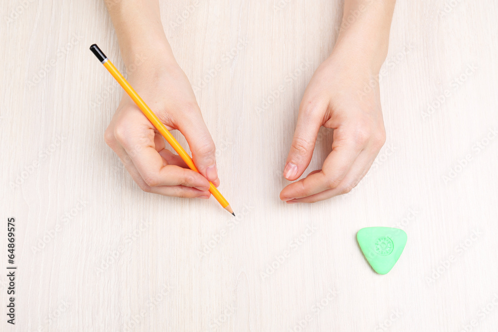 Human hands with pencil and erase rubber Human hands with pencil and erase rubber