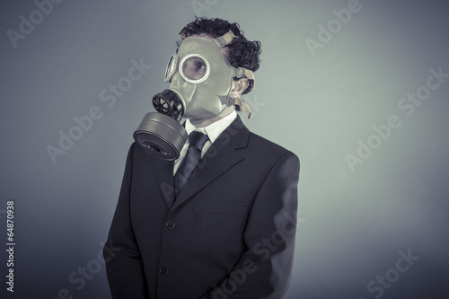 Industry, Business man wearing a gask mask, pollution concept © Fernando Cortés