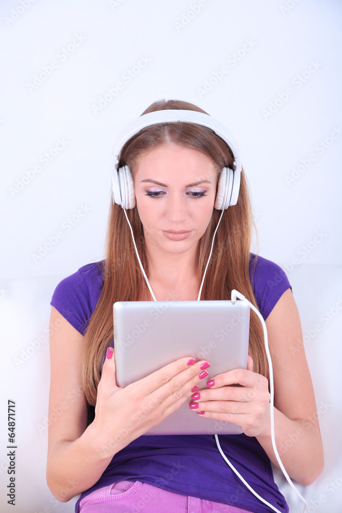 Beautiful girl with PC tablet and headphones. Beautiful girl with PC tablet and headphones.