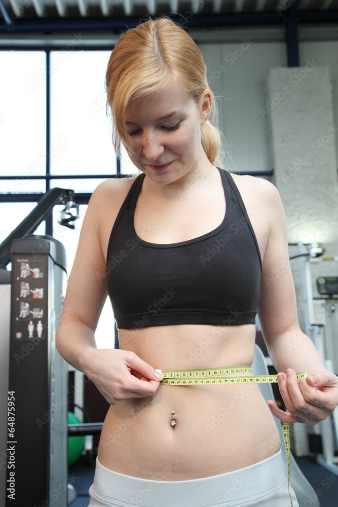 woman with measuring tape in a fitness studio