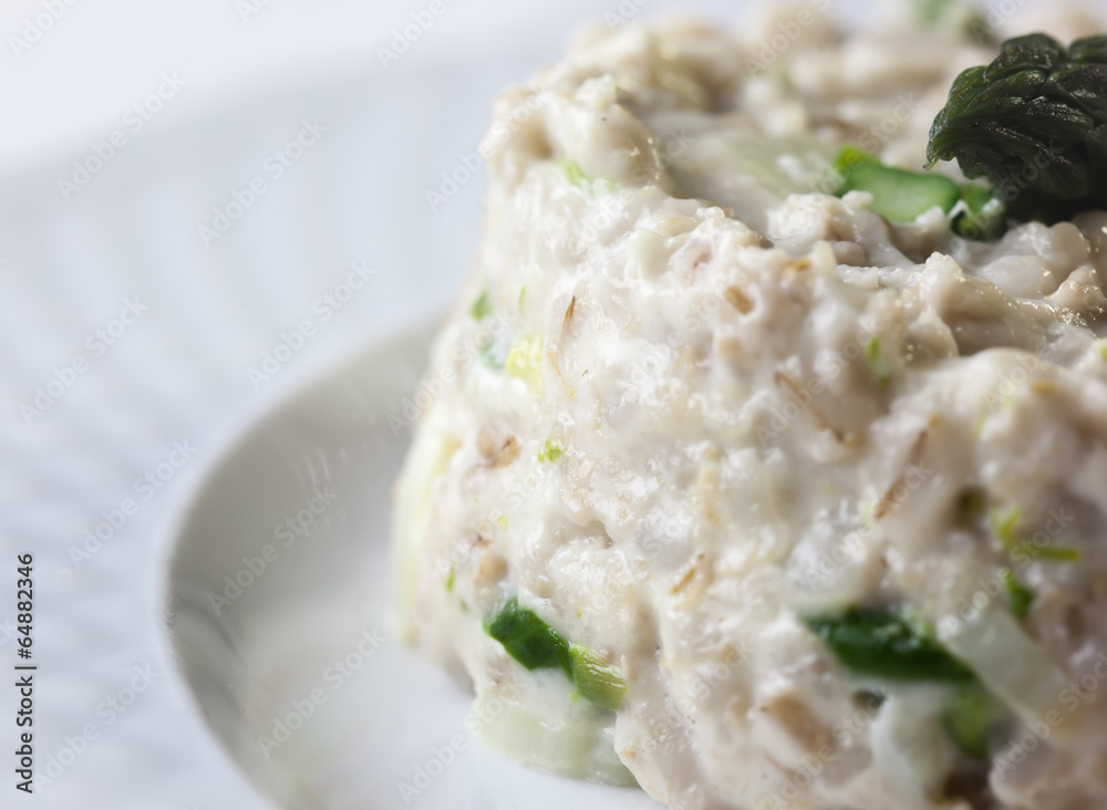 Medallions of pork tenderloin served with asparagus risotto . Medallions of pork tenderloin served with asparagus risotto .