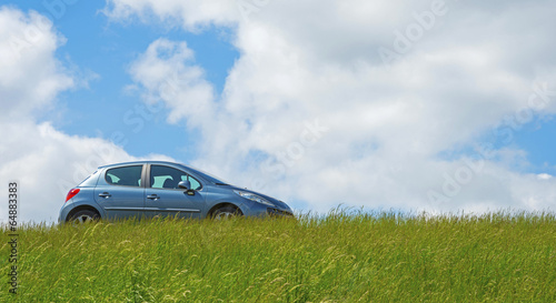 Car parked on a dike in spring