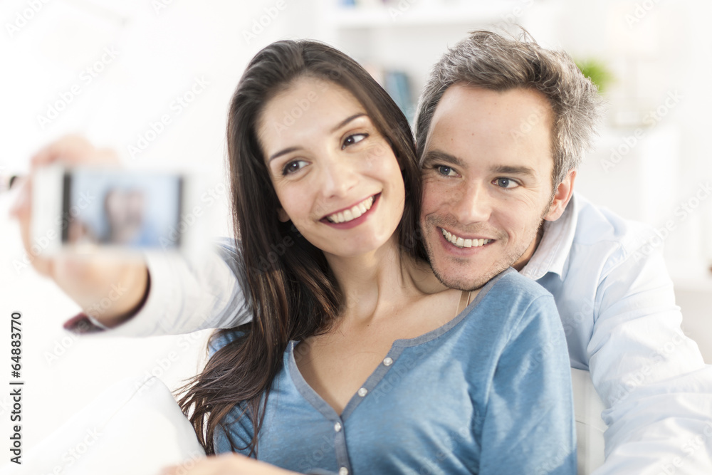 cheerful couple taking a selfie with a smartphone cheerful couple taking a selfie with a smartphone