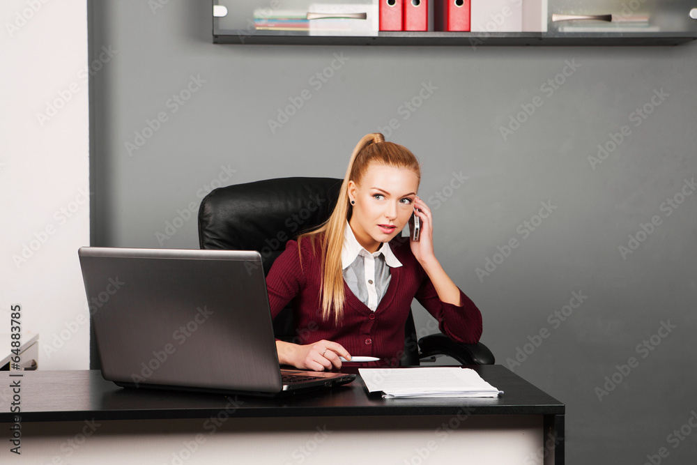 business woman talking on mobile phone in office