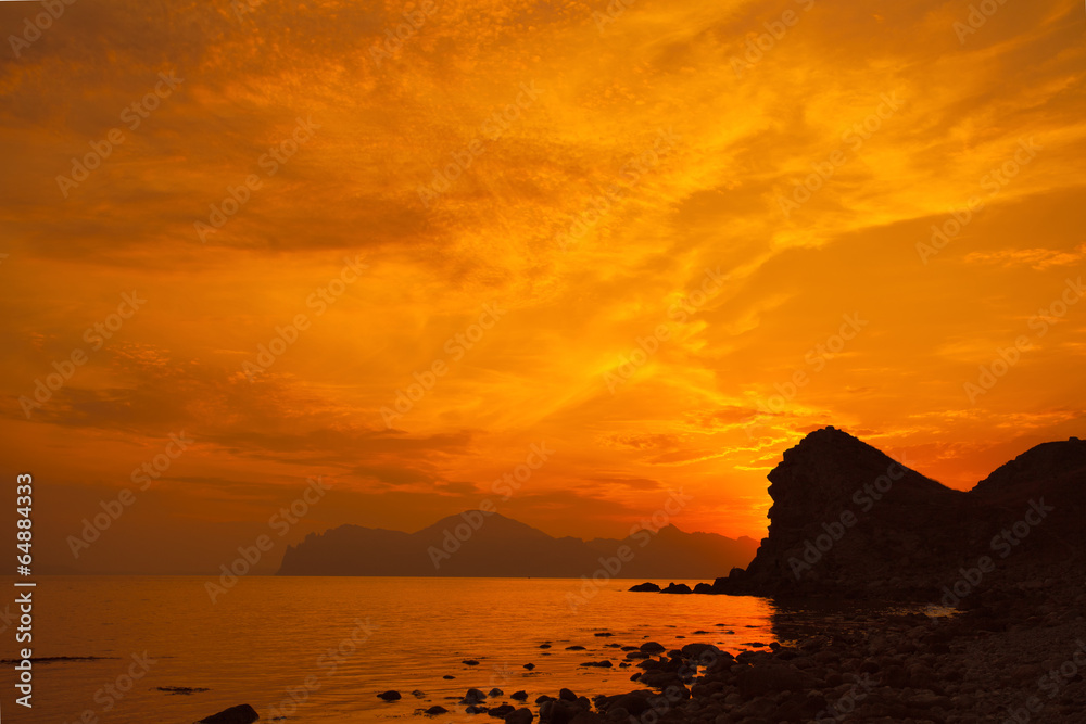 Magic red sunset over rocky coast. Crimea, Ordzonikidze city.
