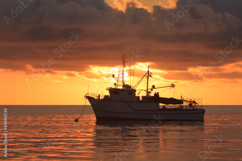 Fishing Boat at Sunset on ocean © Richard Carey