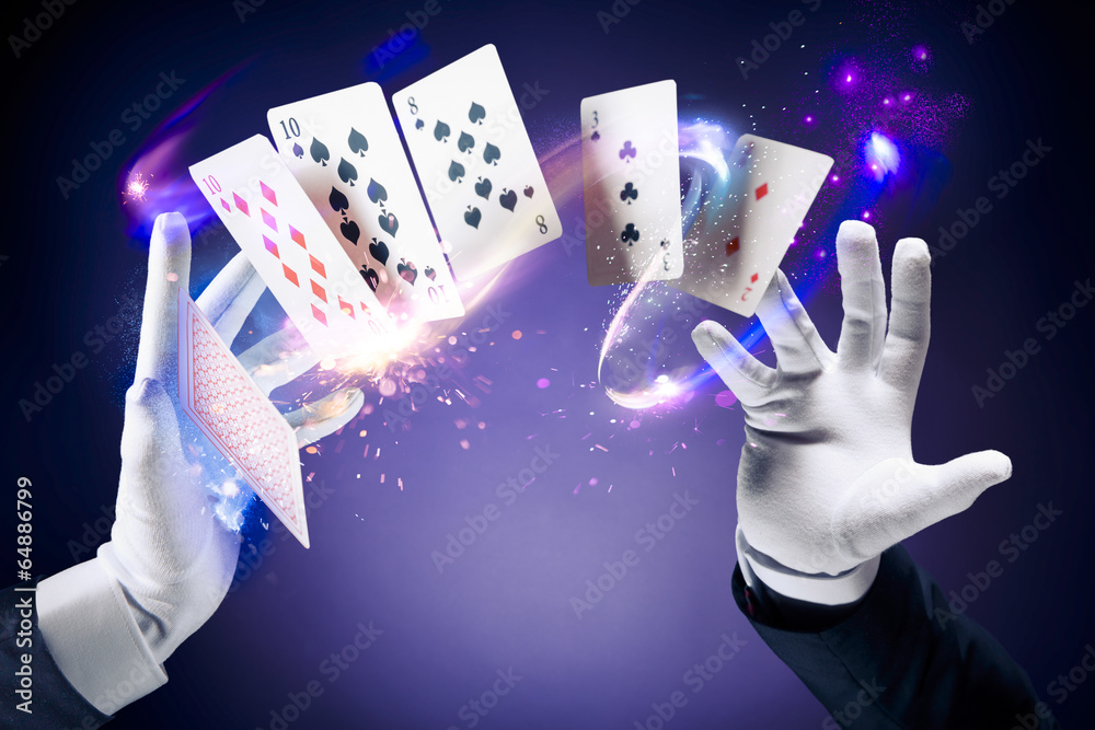Obraz premium High contrast image of magician making card tricks