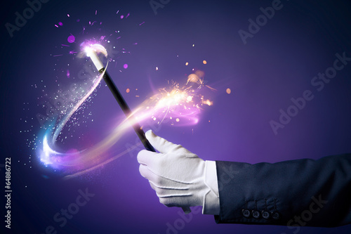 Fototapeta High contrast image of magician hand with magic wand