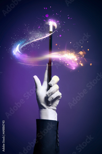 Fotografia High contrast image of magician hand with magic wand