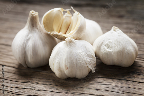 garlic whole and cloves on the wooden background