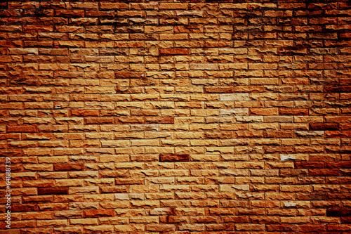 Dark color of orange brick wall.