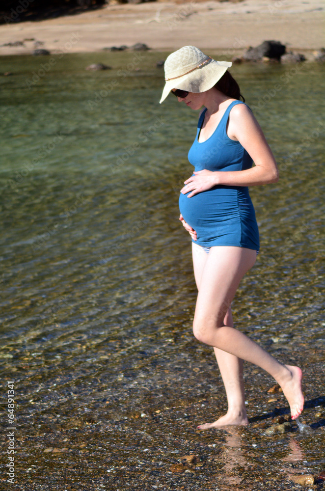 Pregnant woman bathing at sea