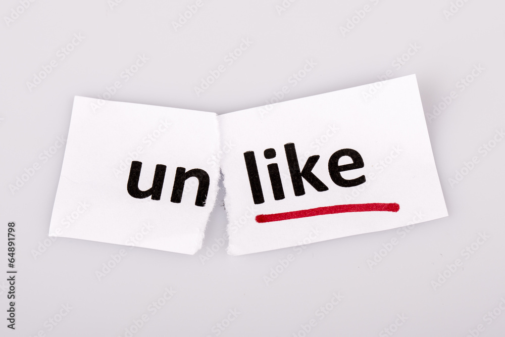 The word unlike changed to like on torn paper The word unlike changed to like on torn paper
