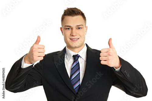 Young businessman in suit showing thumbs up