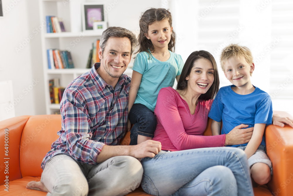 family sitting on a sofa in her living room