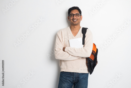 casual indian male student on a sweater and tablet