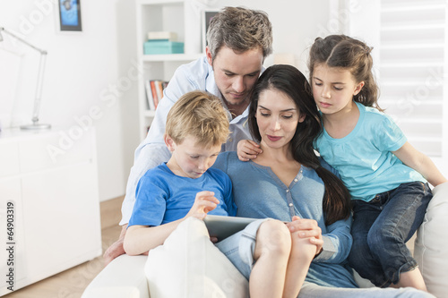 family playing together on a digital tablet