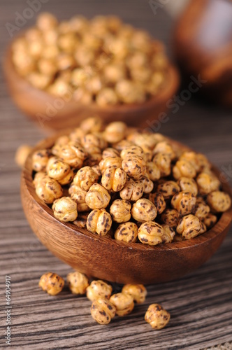 Roasted yellow chickpeas in wooden bowl