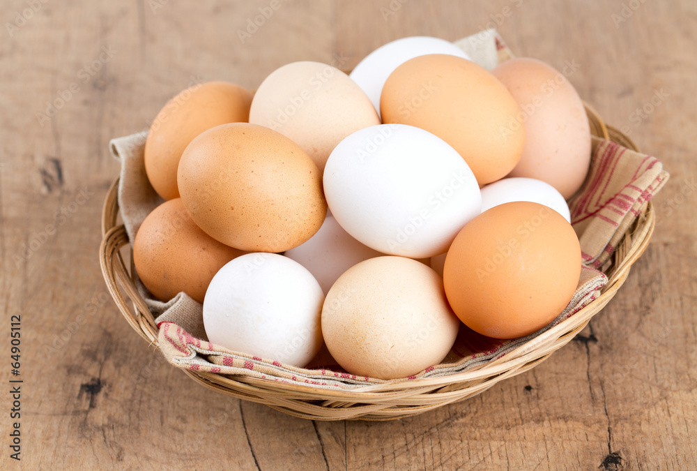 farm eggs in a basket on wooden table farm eggs in a basket on wooden table