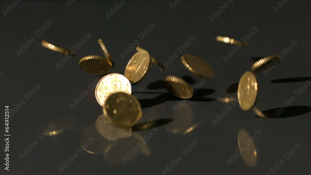 Euro coins falling onto black surface Euro coins falling onto black surface