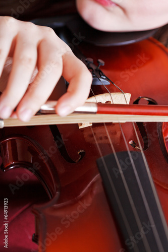 girl playing violin - bow in arm and strings
