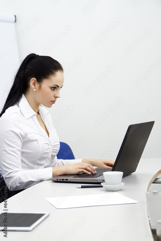 attractive young business woman with computer in office attractive young business woman with computer in office
