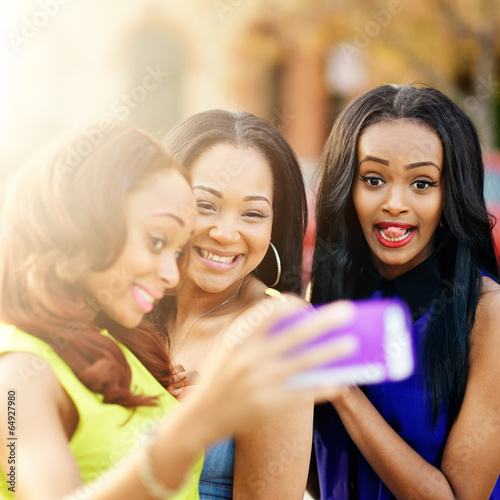 three african girls taking selfies with crazy faces