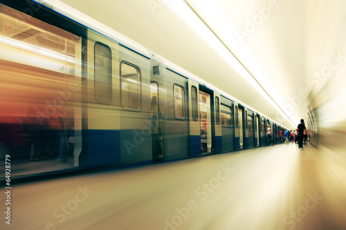 Motion blurred commuters  in subway station.