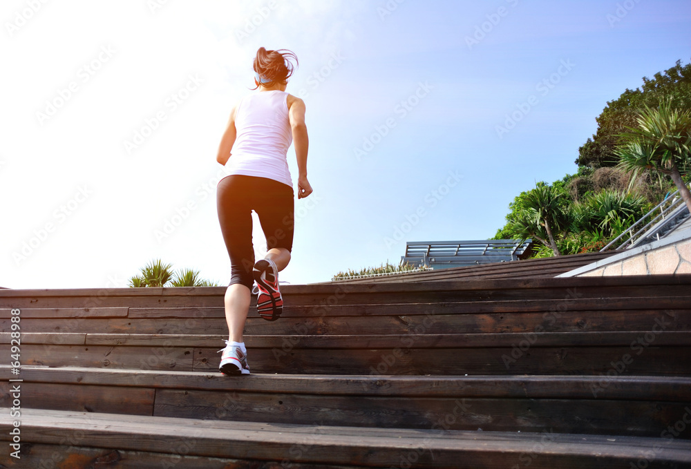 fitness woman runner running  wooden stairs