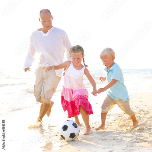 Father and his kids playing football together