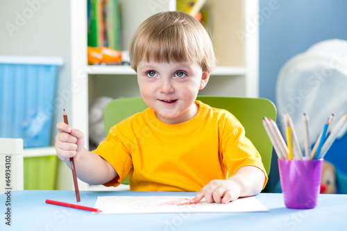 kid boy drawing with pencil...