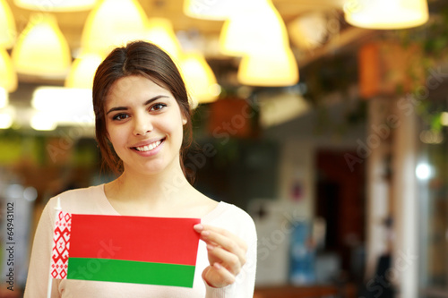 Happy female student holding flag of belarus