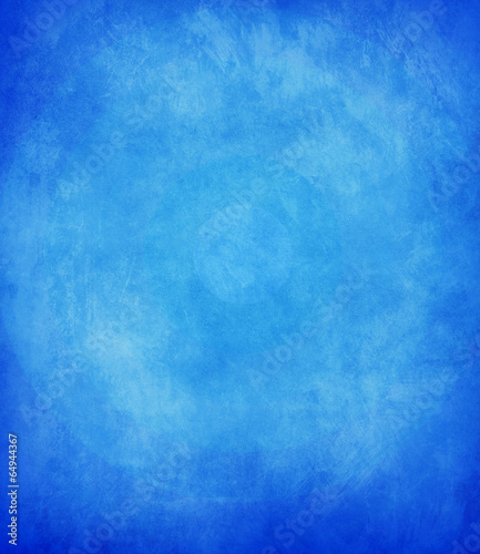 abstract blue background or dark paper with bright center spotli