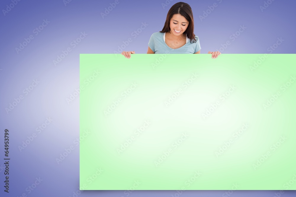 Composite image of pretty brunette showing card Composite image of pretty brunette showing card
