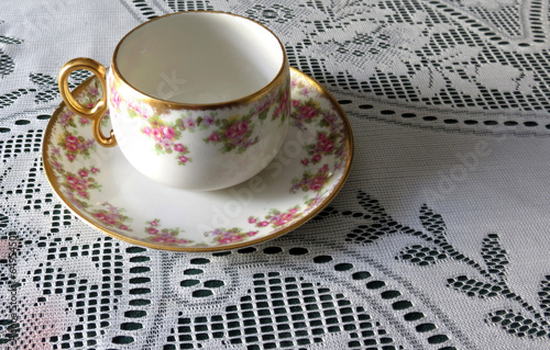 Limoges China Cup and Saucer on Lace Tablecloth