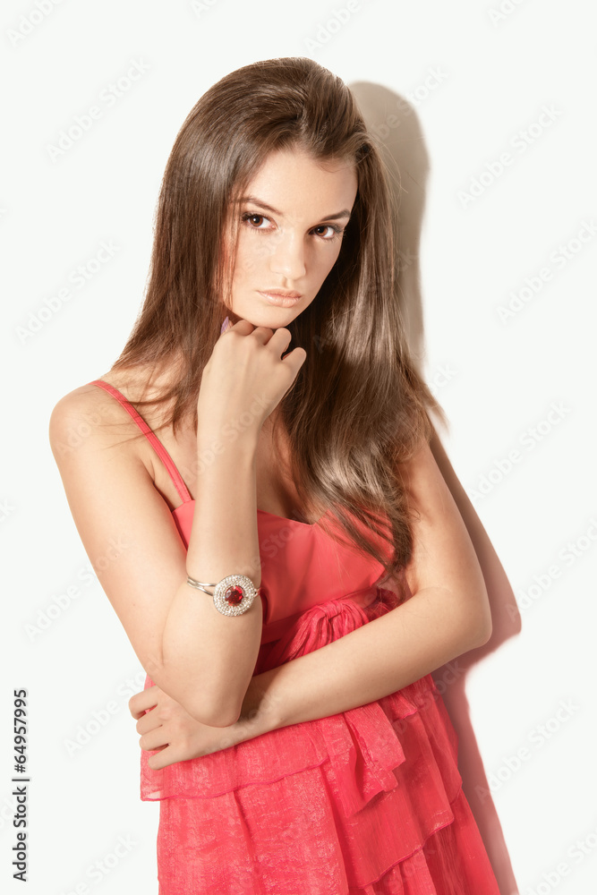 beautiful brunette woman model posing in red dress in the studio beautiful brunette woman model posing in red dress in the studio
