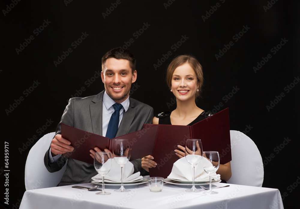 smiling couple with menus at restaurant smiling couple with menus at restaurant