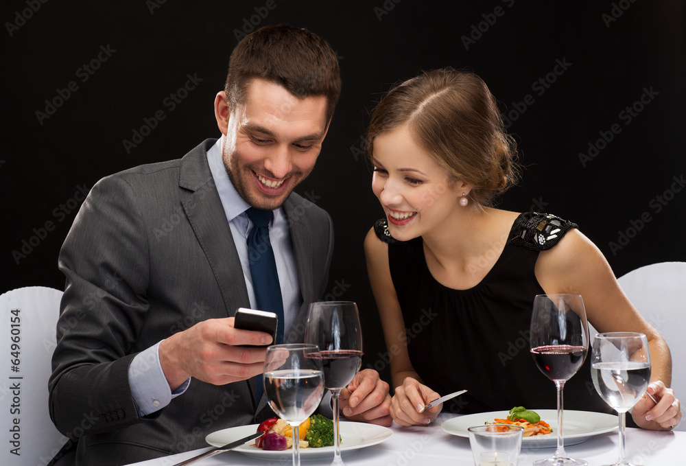 smiling couple eating main course at restaurant smiling couple eating main course at restaurant