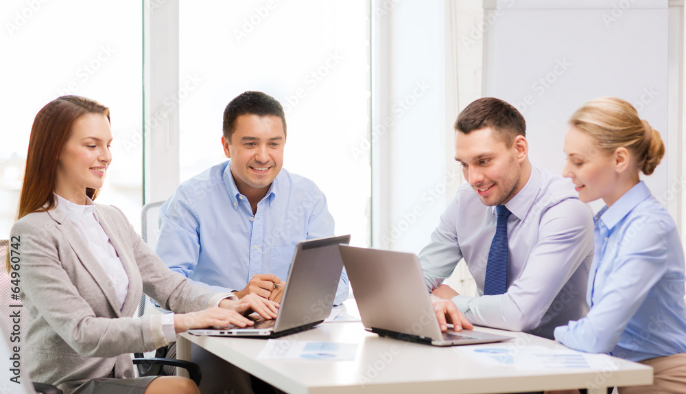 business team working with laptop in office