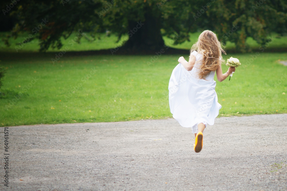 Young girl is runnig away in white dress Young girl is runnig away in white dress