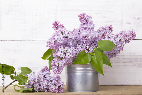bouquet of lilac flowers on white wooden background