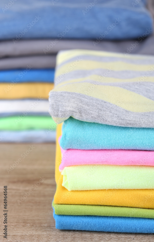 Stack of colorful clothes, on light background Stack of colorful clothes, on light background